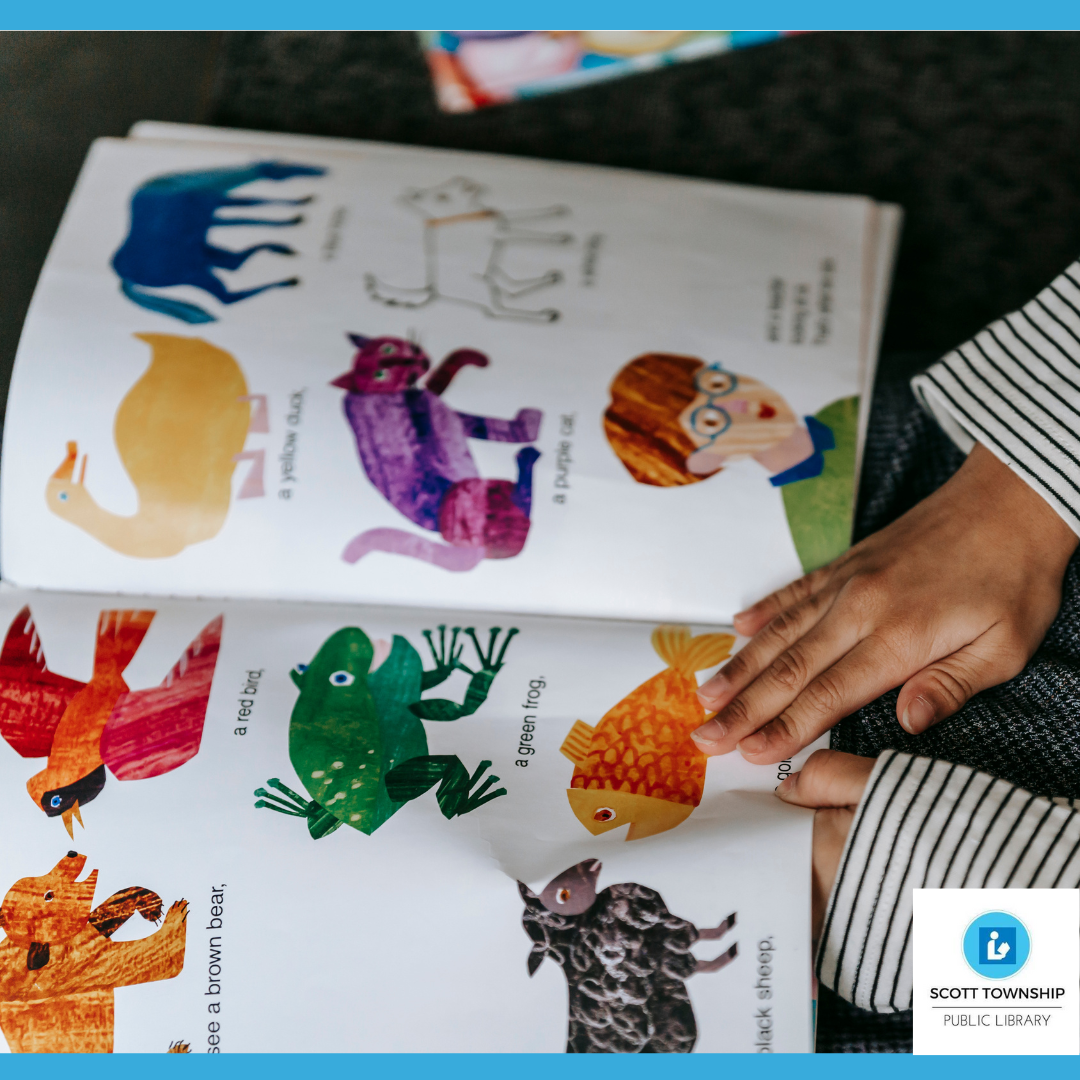 Small hand reading colorful book